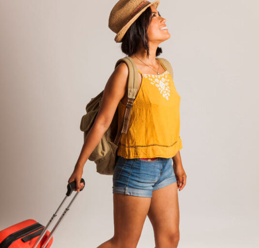 Girl wearing hat and lift backpack is going to trip
