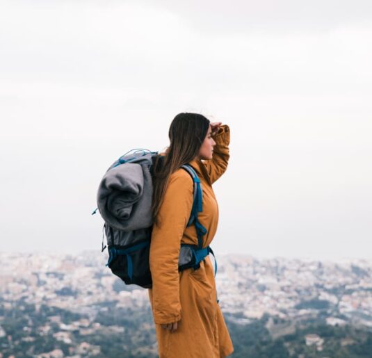 Woman with backpack are looking for a specific area in her trip